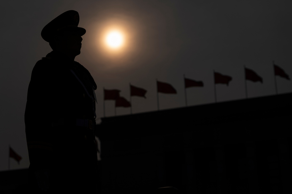 A Chinese paramilitary policeman stands guard as the sun sets after the closing session of the National People's Congress (NPC) at the Great Hall of the People in Beijing, Thursday, March 12, 2026. (AP Photo/Ng Han Guan)