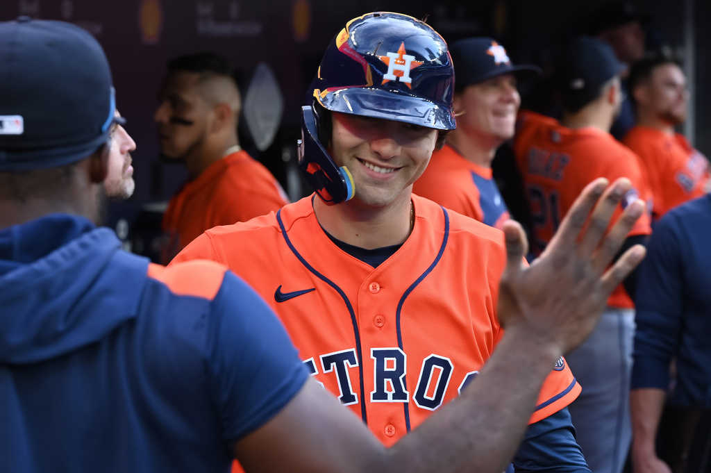 Houston Astros outfielder Joey Loperfido, right, celebrates in the dugout after hitting a three-run home run against the Toronto Blue Jays during eleventh inning MLB baseball action in Toronto on Tuesday June 23, 2026. (Jon Blacker/The Canadian Press via AP)