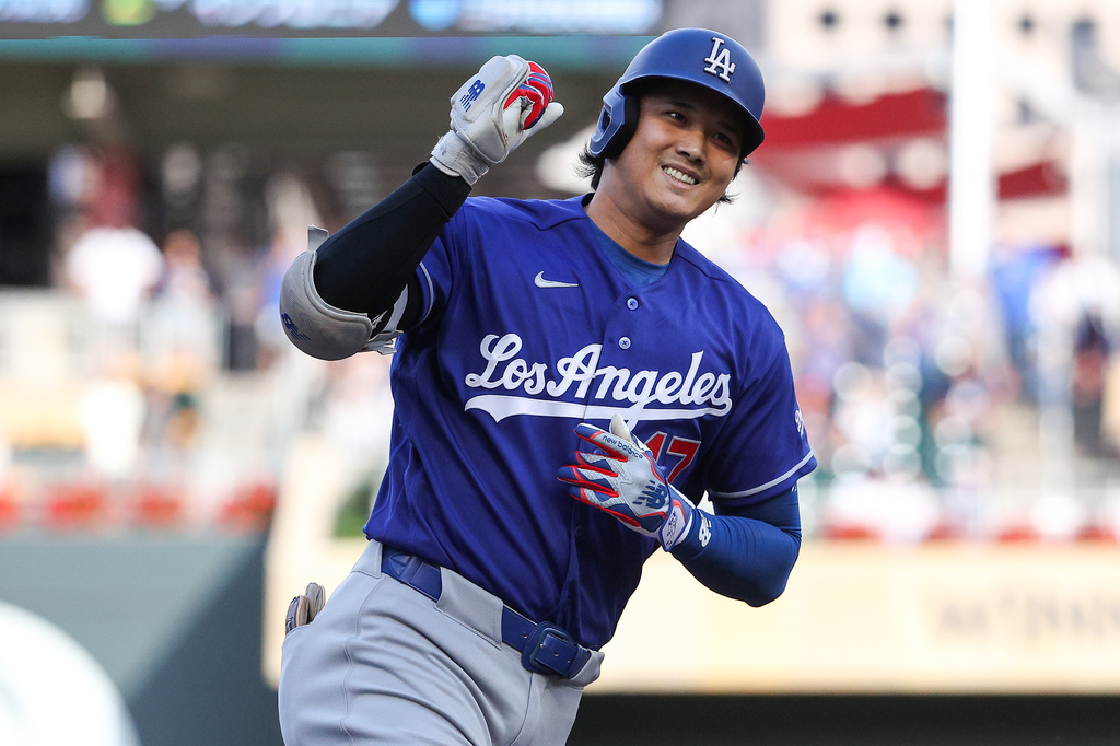 Los Angeles Dodgers designated hitter Shohei Ohtani celebrates as he runs the bases on his solo home run against the Minnesota Twins during the first inning of a baseball game, Monday, June 22, 2026, in Minneapolis. (AP Photo/Matt Krohn)