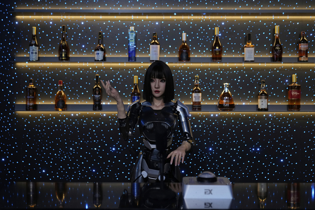 A humanoid robot works at the reception of a restaurant at the Robot Mall, said to be the world's first humanoid intelligent robot 4S store, in Beijing, China, Wednesday, Aug. 6, 2025. (AP Photo/Mahesh Kumar A.)