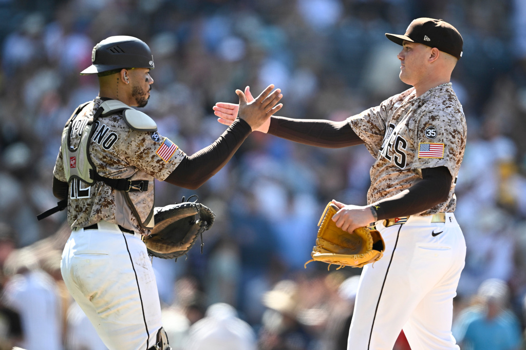 San Diego Padres catcher Luis Campusano, left, and pitcher Adrian Morejon, right, celebrate after their team defeated the San Francisco Giants in a baseball game Sunday, Aug. 2, 2026, in San Diego. (AP Photo/Denis Poroy)