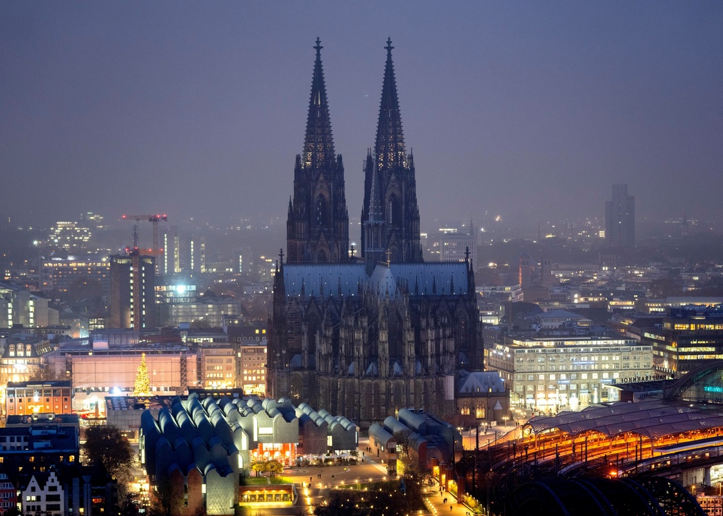 FILE - The illuminated city center with the Cologne Cathedral, in Cologne, Germany, Tuesday, Nov. 29, 2022. (AP Photo/Michael Probst, File)
