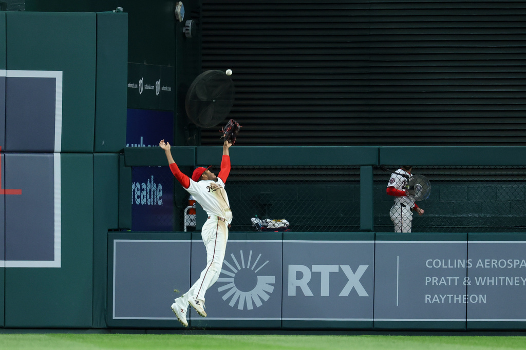 Washington Nationals right fielder James Wood attempts to catch a double hit by Atlanta Braves' Jonah Heim during the seventh inning of a baseball game, Tuesday, April 21, 2026, in Washington. (AP Photo/Terrance Williams)