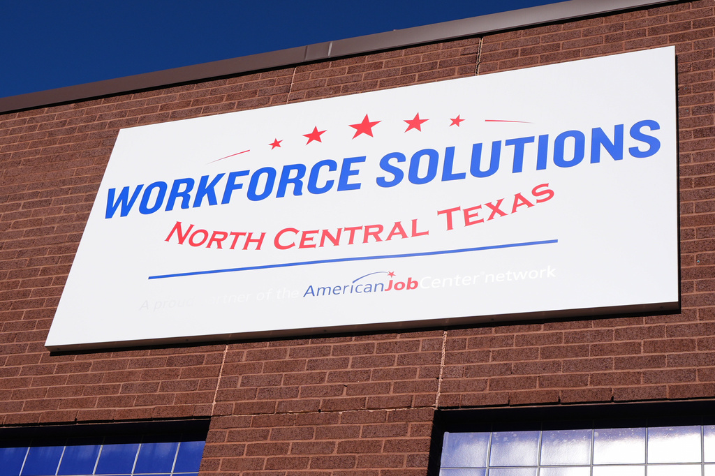 The sign on the exterior of the Workforce Solutions of North Central Texas is shown outside the office Thursday, Oct. 30, 2025, in Plano, Texas. (AP Photo/Tony Gutierrez)