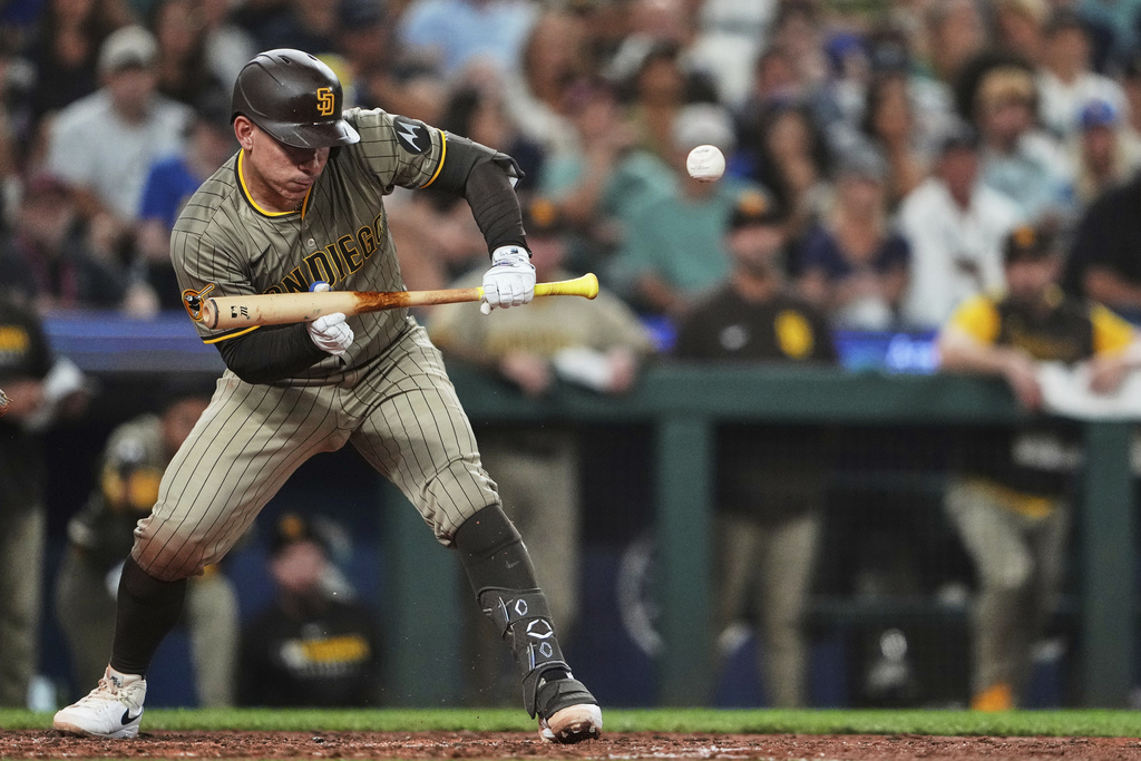 San Diego Padres' Freddy Fermin hits an RBI sacrifice bunt against the Seattle Mariners during the sixth inning of a baseball game Tuesday, Aug. 26, 2025, in Seattle. (AP Photo/Lindsey Wasson)