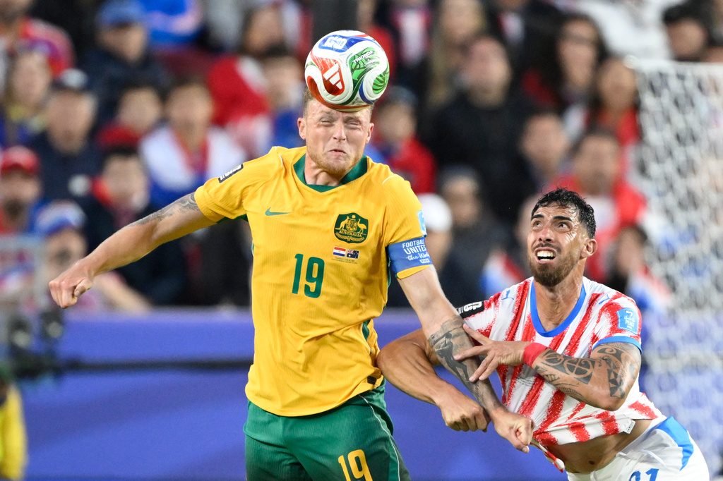 Australia's Harry Souttar (19) battles for the ball with Paraguay's Gabriel Avalos (21) during the World Cup Group D soccer match between Paraguay and Australia in Santa Clara, Calif., near San Francisco, Thursday, June 25, 2026. (AP Photo/Eakin Howard)