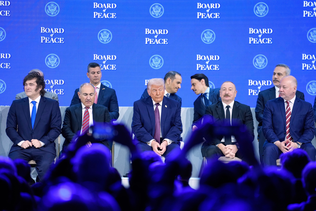 President Trump sits on the podium during a session on the Board of Peace initiative of US President Donald Trump at the Annual Meeting of the World Economic Forum in Davos, Switzerland, Thursday, Jan. 22, 2026. (AP Photo/Markus Schreiber)