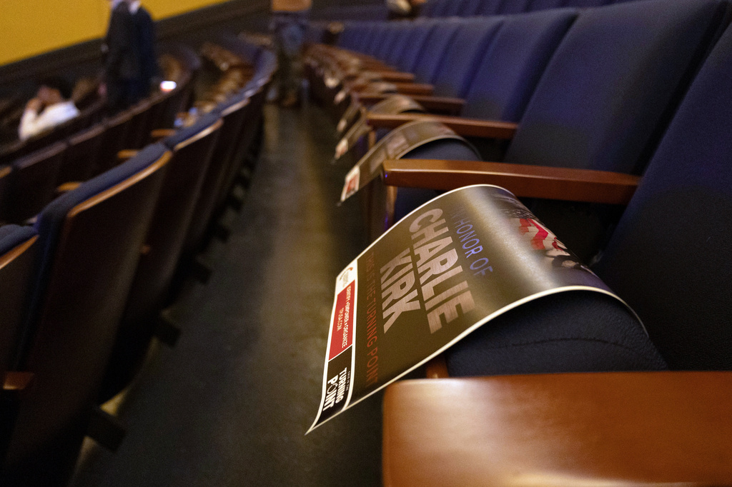 Posters with Charlie Kirk's image are placed on seats for attendees take home at The Turning Point Tour, Thursday, April 2, 2026, in Washington. (AP Photo/Tallulah Brown Van Zee)