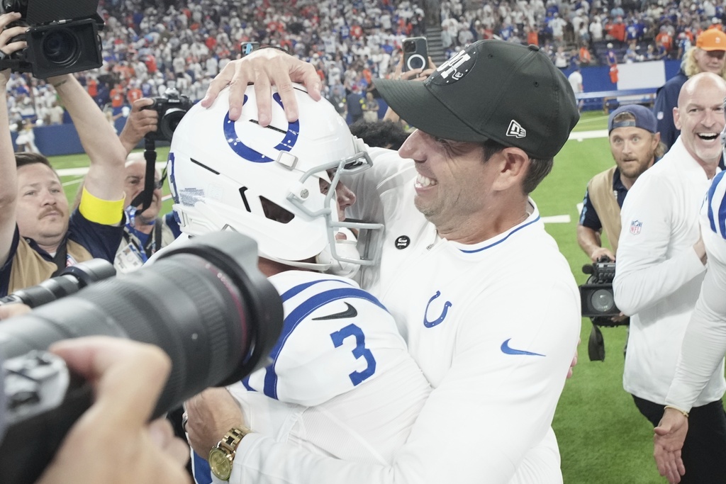 Indianapolis Colts head coach Shane Steichen hugs place kicker Spencer Shrader (3) after Shrader kicked a game winning field goal during the second half an NFL football game against the Denver Broncos, Sunday, Sept. 14, 2025, in Indianapolis. (AP Photo/AJ Mast)