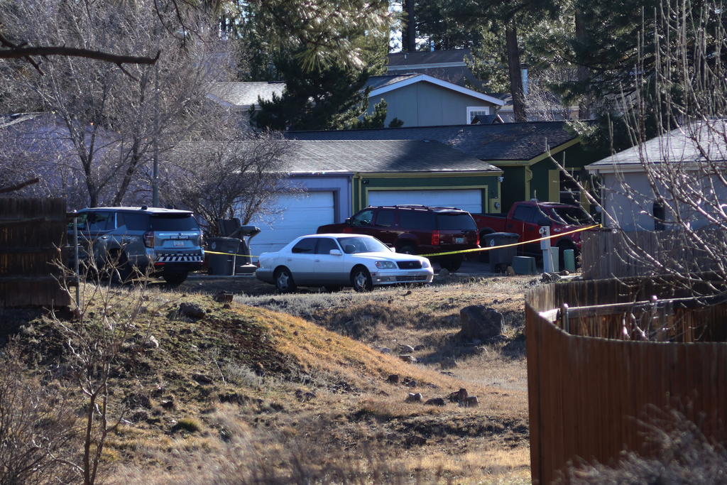 CORRECTS DATE: FILE - Law enforcement respond to a neighborhood in Flagstaff, Ariz., where police say a man opened fire on officers on Feb. 4, 2026. (AP Photo/Cheyanne Mumphrey, File)