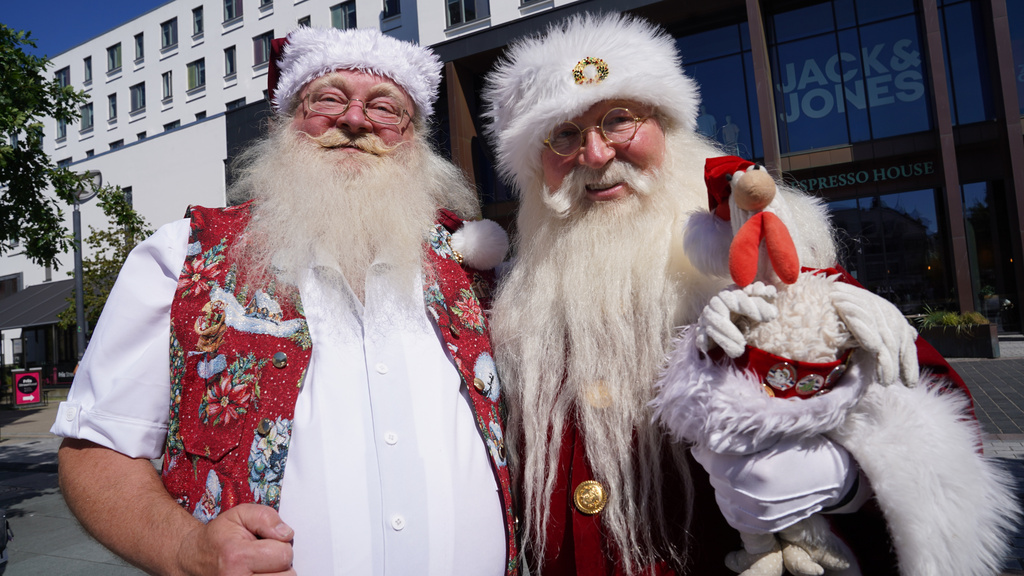 Robert Hercz, a 64-year-old Santa Claus performer from Oslo, Norway, right, pose with an unidentified Santa Claus performer for a photo at the annual World Santa Claus Congress, a colorful midsummer tradition, in Aalborg, Denmark, Wednesday July 8, 2026. (AP Photo/James Brooks)