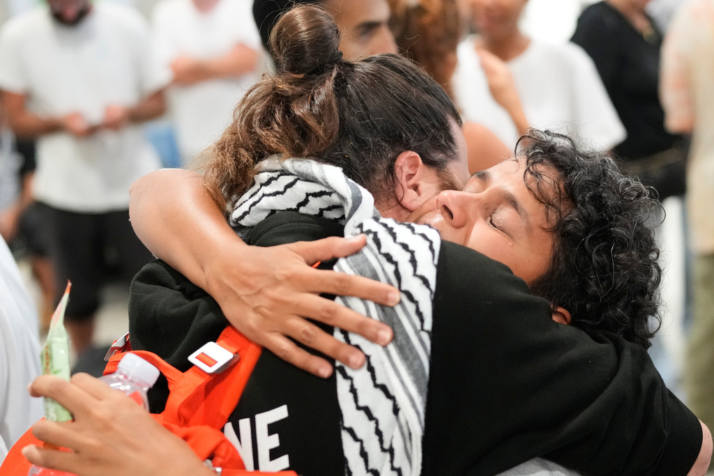 Activists arrive at the Eleftherios Venizelos International Airport in Athens, Monday, Oct. 6, 2025 after being deported from Israel for taking part in a Gaza-bound aid flottila. (AP Photo/Petros Giannakouris)