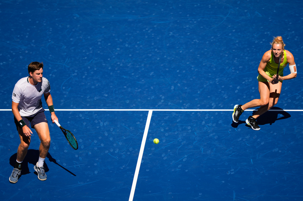 Henry Patten, of Britain, left, and Katerina Siniakova, of the Czech Republic, during a mixed doubles match at the U.S. Open tennis championships, Tuesday, Aug. 25, 2026, in New York. (AP Photo/Yuki Iwamura)
