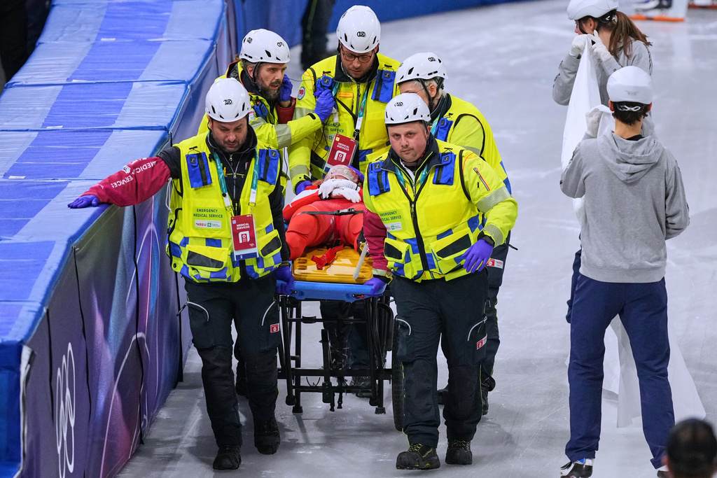Kamila Sellier of Poland is helped after falling during a short track speed skating women's 1500 meters quarterfinal at the 2026 Winter Olympics, in Milan, Italy, Friday, Feb. 20, 2026. (AP Photo/Stephanie Scarbrough)