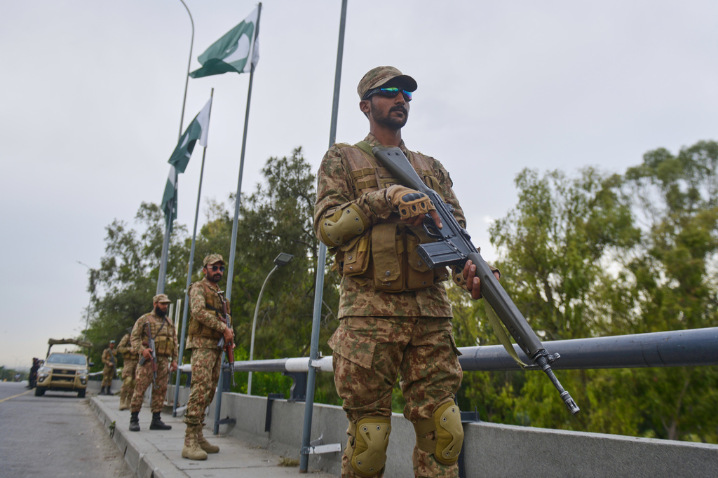 Army soldiers take positions in an overhead bridge to ensure security in Islamabad, Pakistan, Friday, April 24, 2026. (AP Photo/M.A. Sheikh)