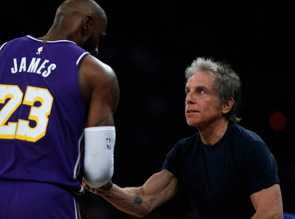 Los Angeles Lakers forward LeBron James, left, talks with actor Ben Stiller during the first half of an NBA basketball game, Sunday, Feb. 1, 2026, in New York. (AP Photo/John Munson)