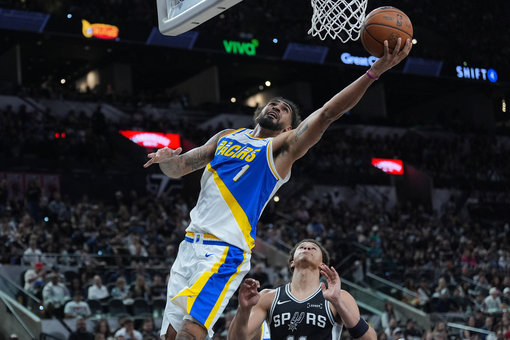 Indiana Pacers forward Obi Toppin (1) drives to the basket over San Antonio Spurs forward Carter Bryant (11) during the second half of an NBA basketball game in San Antonio, Saturday, March 21,2026. (AP Photo/Eric Gay)