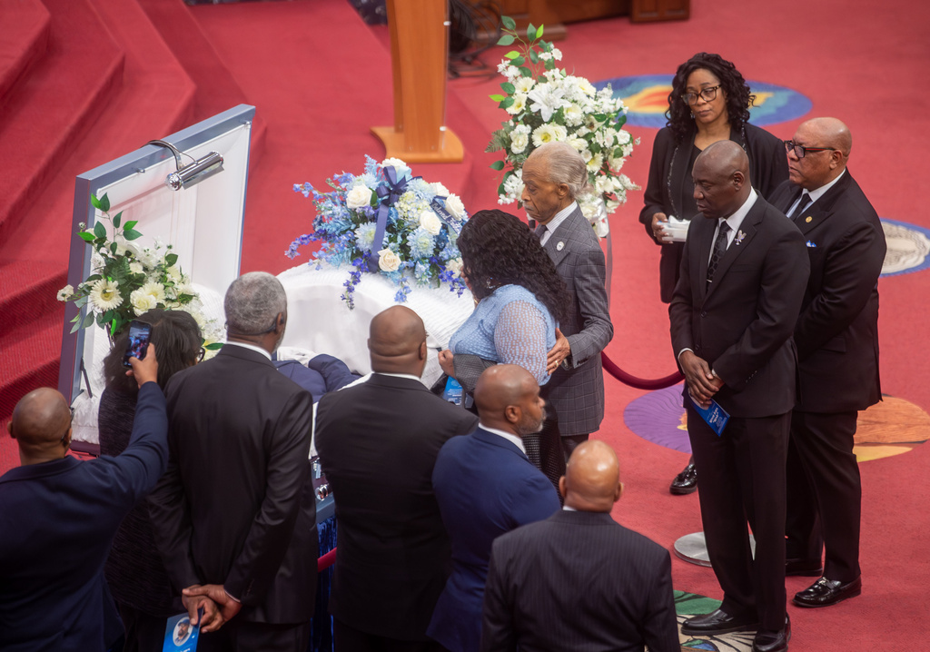 The Rev. Al Sharpton walks with Audrey Jones to pay respects to her brother Steven Jones, a man in a mental health crisis who was shot by police, during Jones' funeral service at The First Cathedral, Thursday, March 26, 2026 in Bloomfield, Conn. (Aaron Flaum/Hartford Courant via AP)