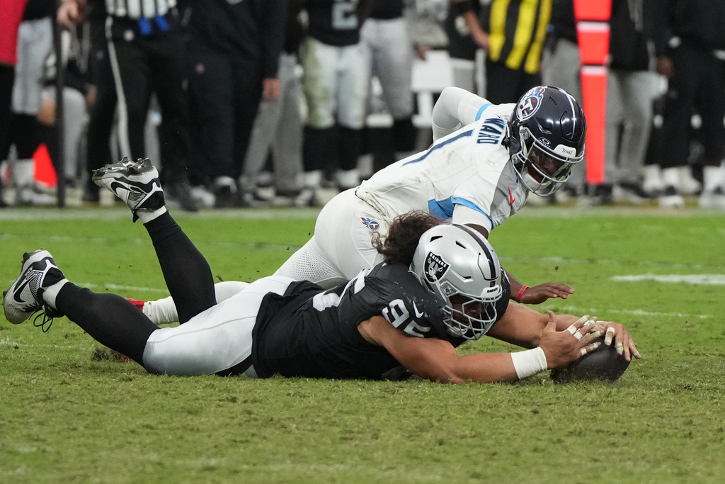 Las Vegas Raiders defensive tackle Leki Fotu (95) recovers a fumble by Tennessee Titans quarterback Cam Ward (1) during the second half of an NFL football game, Sunday, Oct. 12, 2025, in Las Vegas. (AP Photo/Rick Scuteri)
