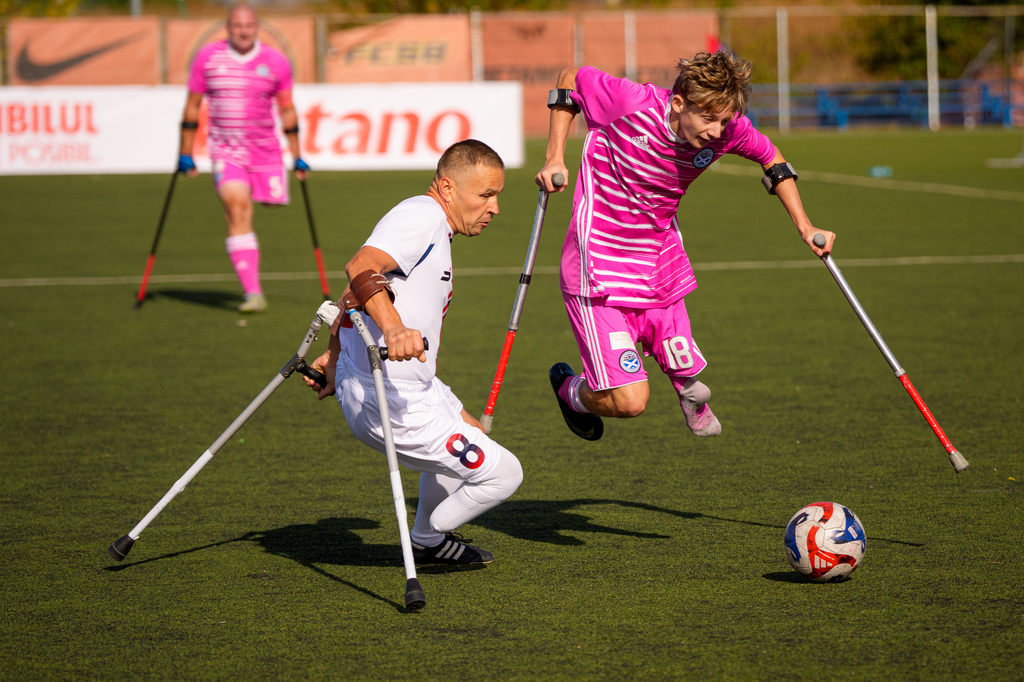 FCSB's Marian Sacacol, left, challenges for the ball with Ayr United's Charlie Hewson during an amputee soccer match between FCSB and Ayr United in the inaugural EAFF Conference League in Bucharest, Romania, Thursday, Sept. 24, 2026. (AP Photo/Andreea Alexandru)