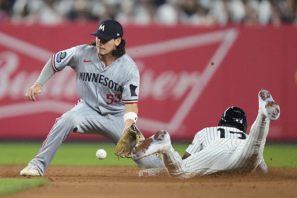 New York Yankees' Jazz Chisholm Jr., right, slides past Minnesota Twins' Ryan Fitzgerald (53) to steal second base during the sixth inning of a baseball game Monday, Aug. 11, 2025, in New York. (AP Photo/Frank Franklin II)
