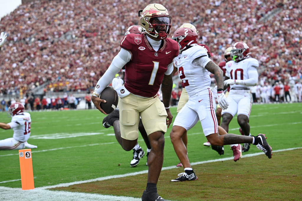 FILE - Florida State quarterback Tommy Castellanos (1) rushes for a touchdown against Alabama during the first half of an NCAA college football game, Saturday, Aug. 30, 2025, in Tallahassee, Fla. (AP Photo/Phelan M. Ebenhack,File)