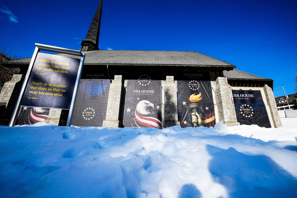 Posters cover the church hosting the United States House on the eve of the start of the Annual Meeting of the World Economy Forum in Davos, Switzerland, Sunday, Jan. 18, 2026. (AP Photo/Markus Schreiber)