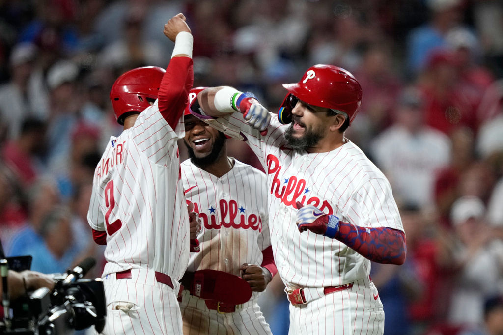 Philadelphia Phillies' Kyle Schwarber, from right, Bryan de la Cruz and Justin Crawford celebrate after Schwarber's grand slam during the sixth inning of a baseball game against the Houston Astros Wednesday, Sept. 9, 2026, in Philadelphia. (AP Photo/Matt Slocum)
