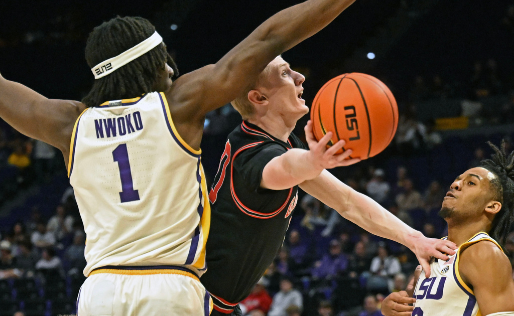 Georgia guard Blue Cain (0) attempts to drive to the basket between LSU forward Mike Nwoko (1) and guard Jalen Reece (2) during an NCAA college basketball game, Saturday, Feb. 7, 2026, in Baton Rouge, La. (Hilary Scheinuk/The Advocate via AP)