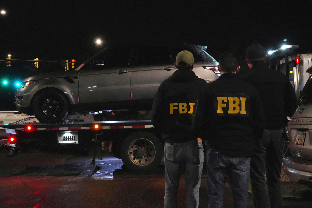 Pima County sheriff and FBI take away a Range Rover from a Culver’s parking lot in Tucson, Ariz. early Saturday, Feb. 14, 2026. (AP Photo/Ty ONeil)