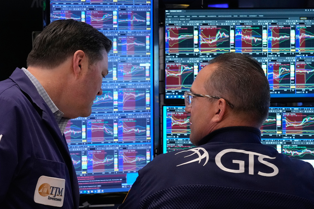 Trader Terrance McCauley, left, and specialist Anthony Matesic confer on the floor of the New York Stock Exchange, Monday, April 20, 2026. (AP Photo/Richard Drew)