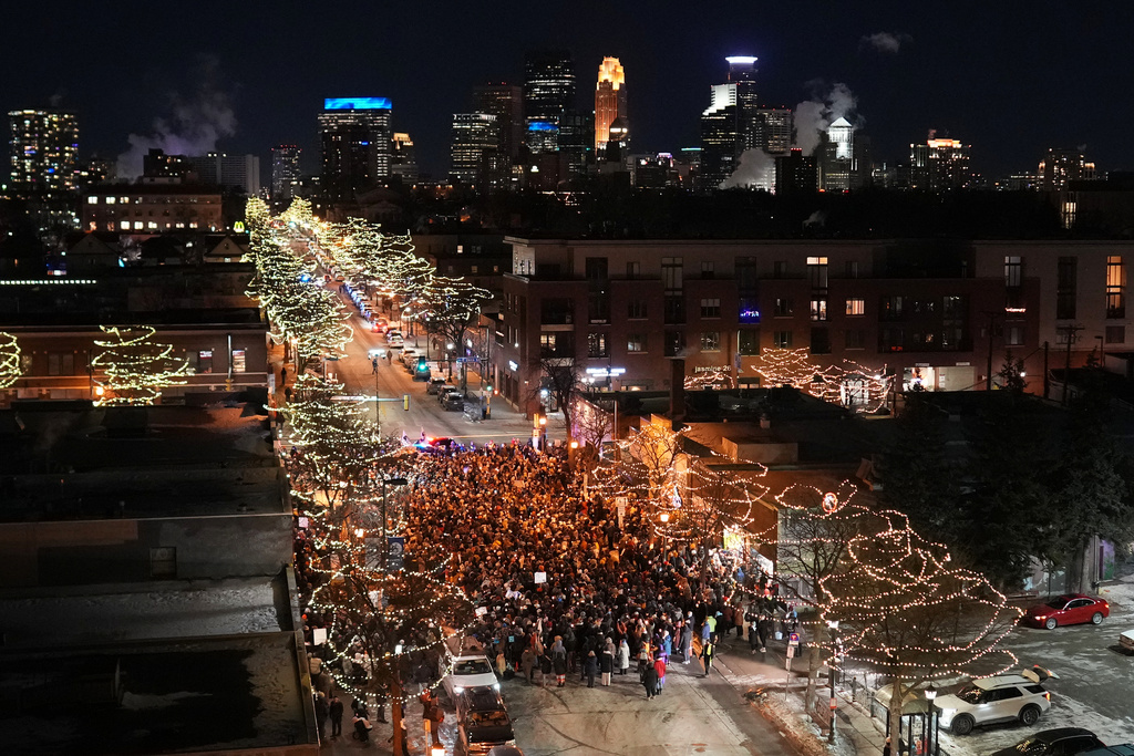 People gather during a vigil where Alex Pretti was shot and killed by federal immigration enforcement in Minneapolis, on Wednesday, Jan. 28, 2026. (AP Photo/Adam Gray)