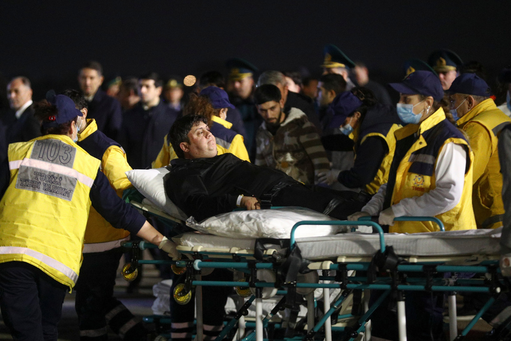 FILE - Injured passengers from an Azerbaijan Airline jet that crashed near Aktau, Kazakhstan, are transported from a medical plane at the Heydar Aliyev International Airport outside Baku, Azerbaijan, on Dec. 26, 2024. (AP Photo, File)