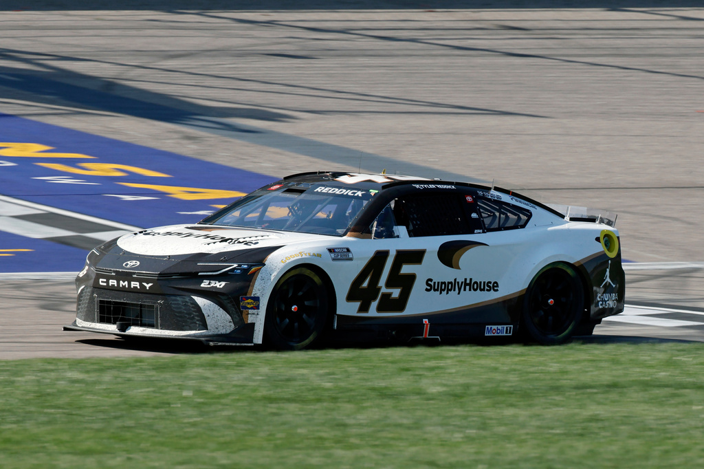 Tyler Reddick crosses the finish line to win a NASCAR Cup Series auto race at Kansas Speedway in Kansas City, Kan., Sunday, April 19, 2026. (AP Photo/Colin E. Braley)