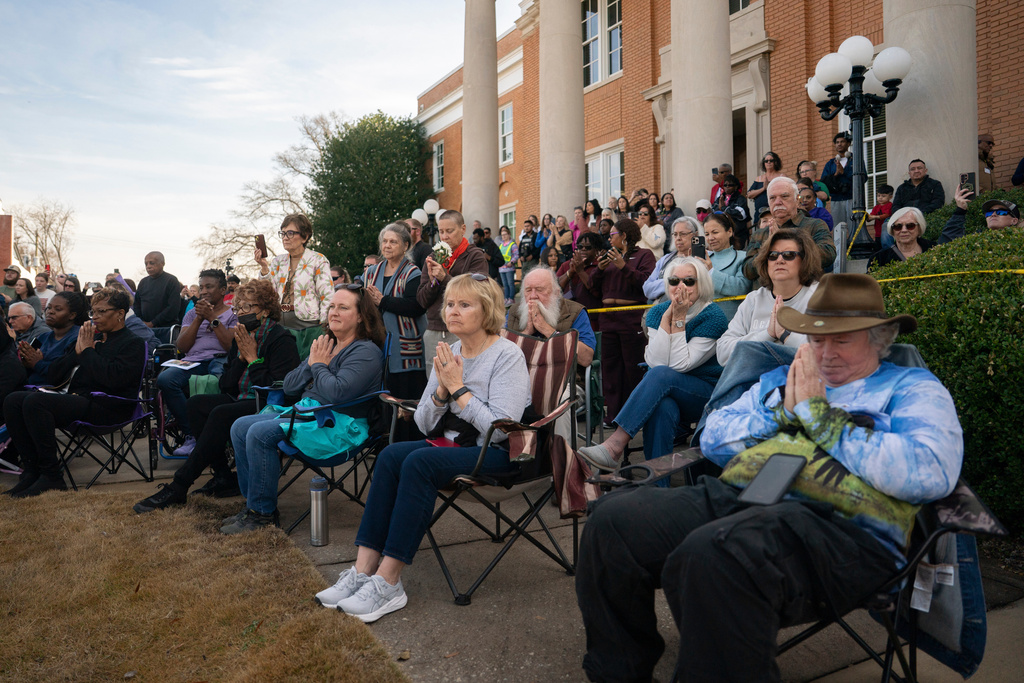 Supporters pray with Buddhist monks who are participating in the, "Walk For Peace," Thursday, Jan. 8, 2026, in Saluda, S.C. (AP Photo/Allison Joyce)