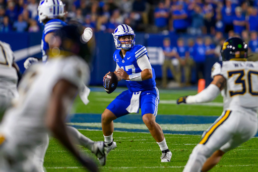 BYU quarterback Bear Bachmeier, center, looks to pass the ball during the first half of an NCAA college football game against West Virginia, Friday, Oct. 3, 2025, in Provo, Utah. (AP Photo/Tyler Tate) BYU quarterback Bear Bachmeier, center, looks to pass the ball during the first half of an NCAA college football game against West Virginia, Friday, Oct. 3, 2025, in Provo, Utah. (AP Photo/Tyler Tate)