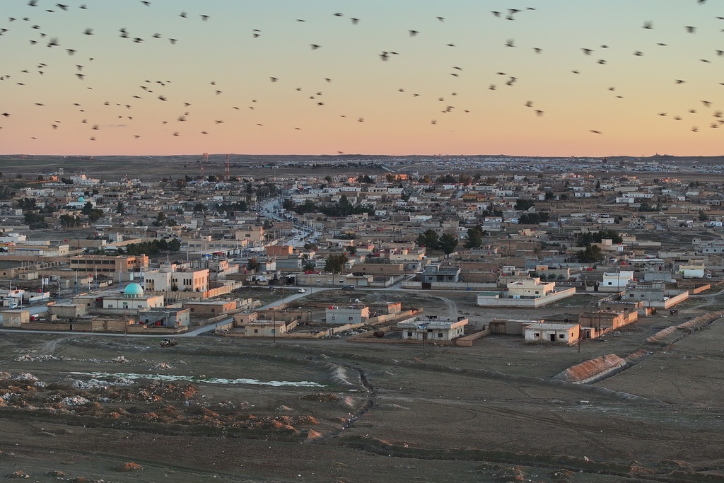 An aerial view shows the town of al-Hol and, in the background, the camp, which holds thousands of Islamic State group members and their families and is now under the control of the Syrian government following the withdrawal of the Syrian Democratic Forces (SDF), in al-Hassakeh province, northeastern Syria, Wednesday, Feb. 4, 2026. (AP Photo/Ghaith Alsayed)