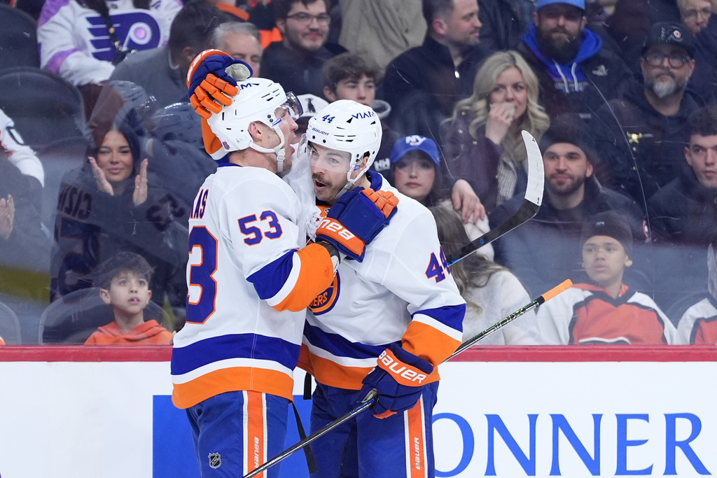 New York Islanders' Jean-Gabriel Pageau, right, and Casey Cizikas celebrate after Pageau's goal during the first period of an NHL hockey game against the Philadelphia Flyers Monday, Jan. 26, 2026, in Philadelphia. (AP Photo/Matt Slocum)
