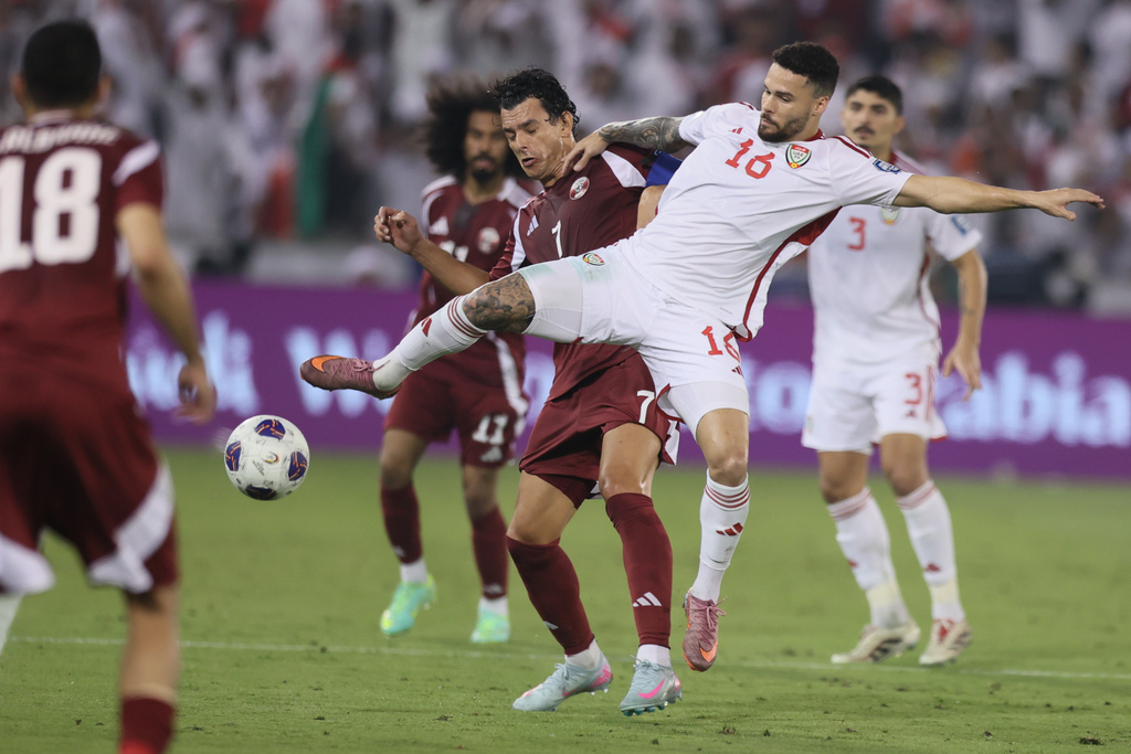 Qatar's Andreas Sebastian, center rear, fights for the ball with Marcus Vinicius of United Arab Emirates during the 2026 World Cup qualifying soccer match between Qatar and United Arab Emirates at the Hamad Bin Jassim Stadium in Doha, Tuesday, Oct. 14, 2025. (AP Photo/Hussein Sayed)