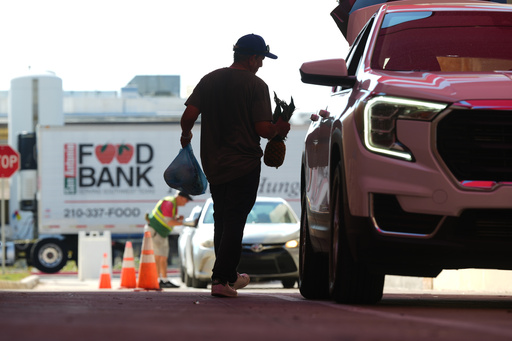 Volunteer Joel Hernandez helps load a vehicle during a food distribution targeting federal employee households affected by the federal shutdown as well as SNAP recipients, Monday, Oct. 27, 2025, in San Antonio. (AP Photo/Eric Gay) Volunteer Joel Hernandez helps load a vehicle during a food distribution targeting federal employee households affected by the federal shutdown as well as SNAP recipients, Monday, Oct. 27, 2025, in San Antonio. (AP Photo/Eric Gay)