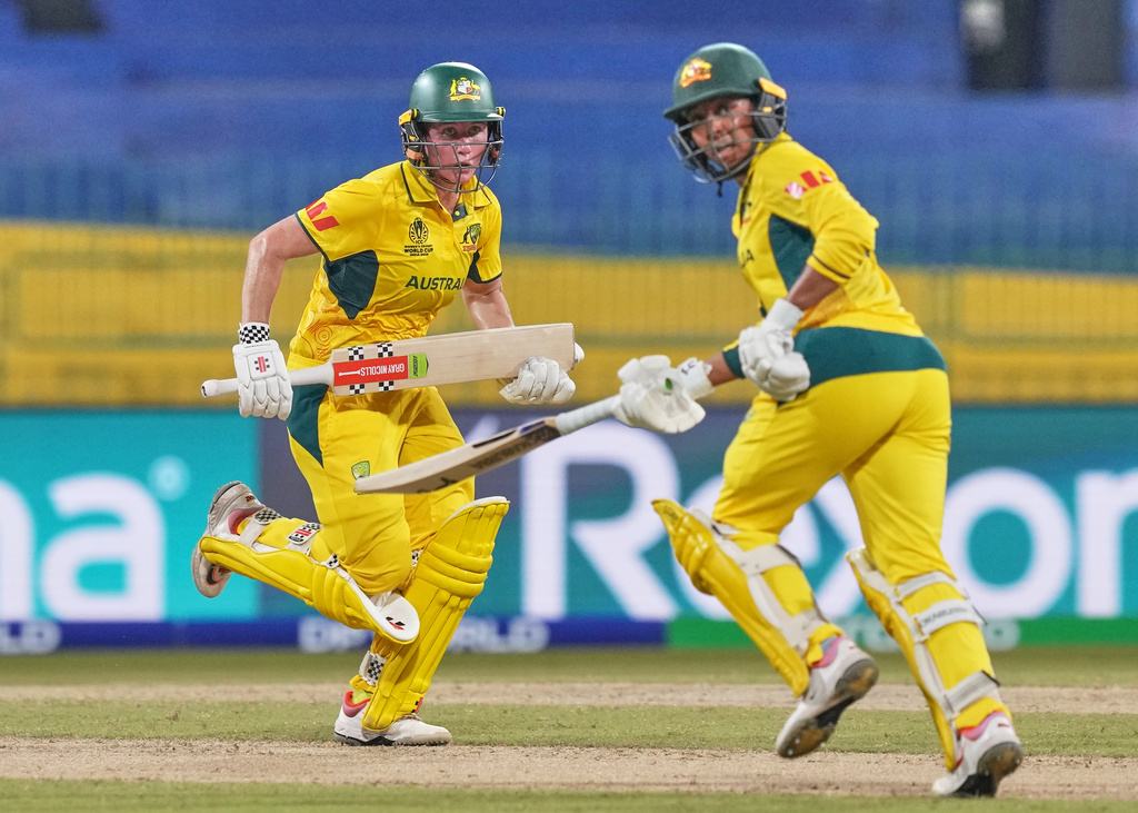 Australia's Beth Mooney, left, and Alana King run between the wickets to score during the ICC Women's Cricket World Cup match between Australia and Pakistan at Premadasa Stadium in Colombo, Sri Lanka, Wednesday, Oct, 8, 2025. (AP Photo/Eranga Jayawardena)