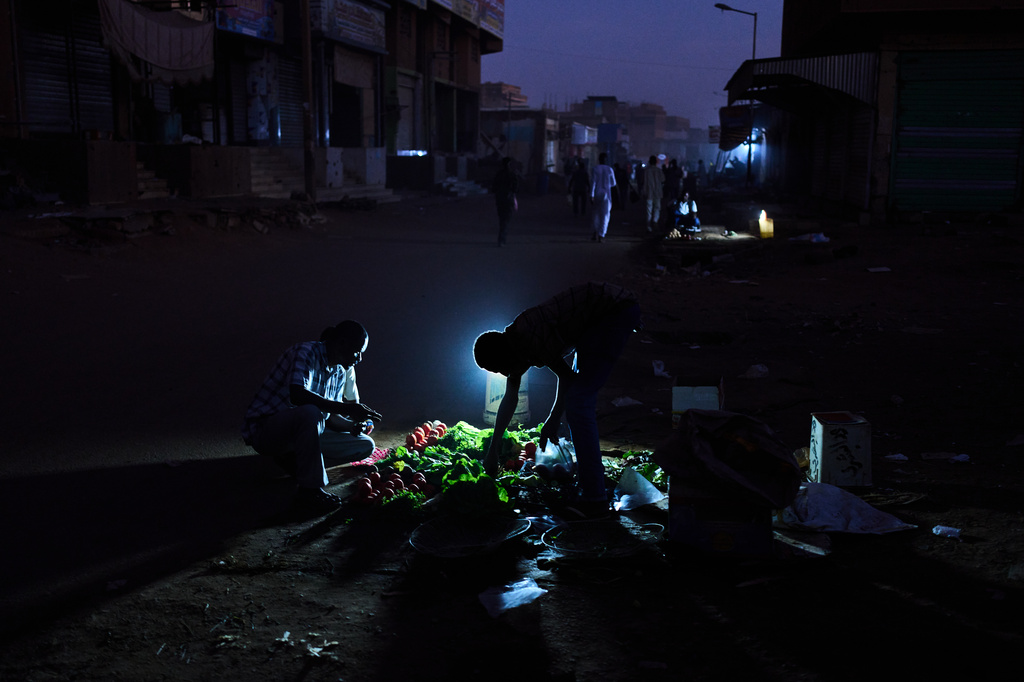 A Sudanese man buys vegetables in downtown Omdurman, on the outskirts of Khartoum, Sudan, Friday, April 17, 2026. (AP Photo/Bernat Armangue)