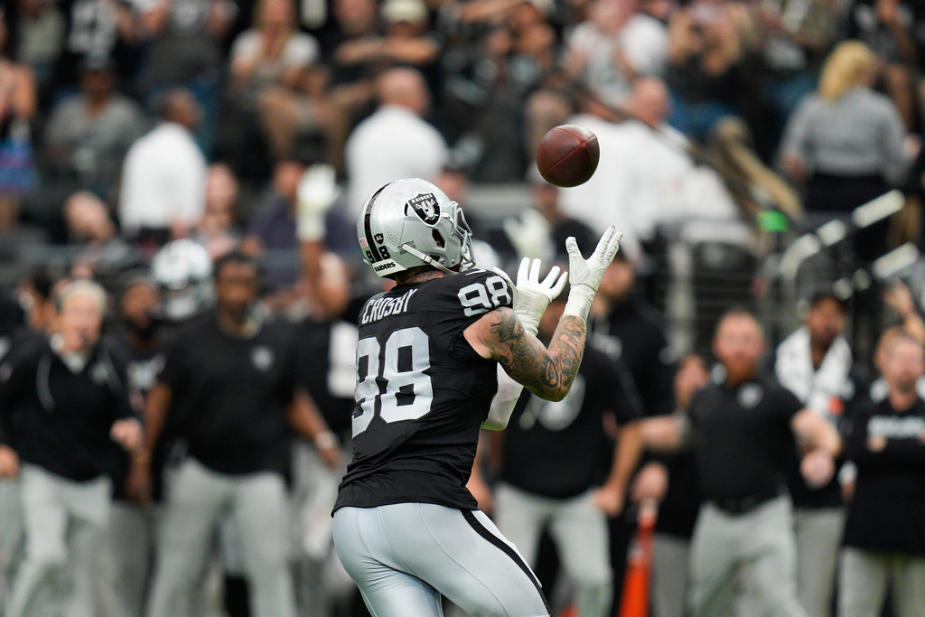 Las Vegas Raiders defensive end Maxx Crosby (98) intercepts a pass against the Chicago Bears during the first half of an NFL football game Sunday, Sept. 28, 2025, in Las Vegas. (AP Photo/John Locher)