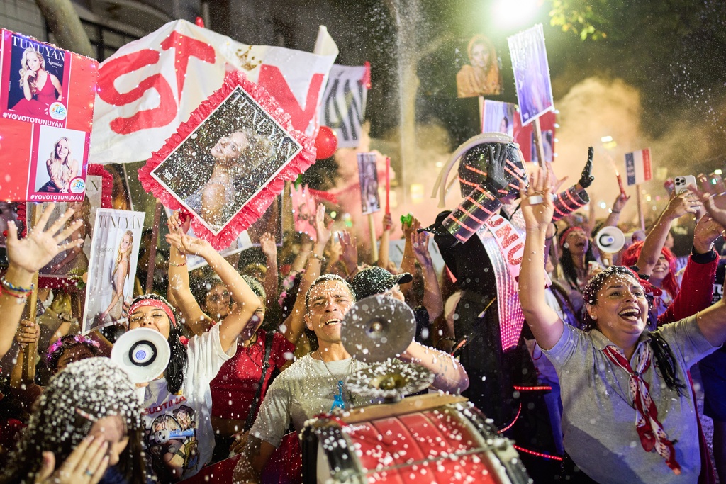 Spectators cheer as they watch the Via Blanca parade during the annual grape harvest celebration in Mendoza, Argentina, Friday, March 6, 2026. (AP Photo/Rodrigo Abd)