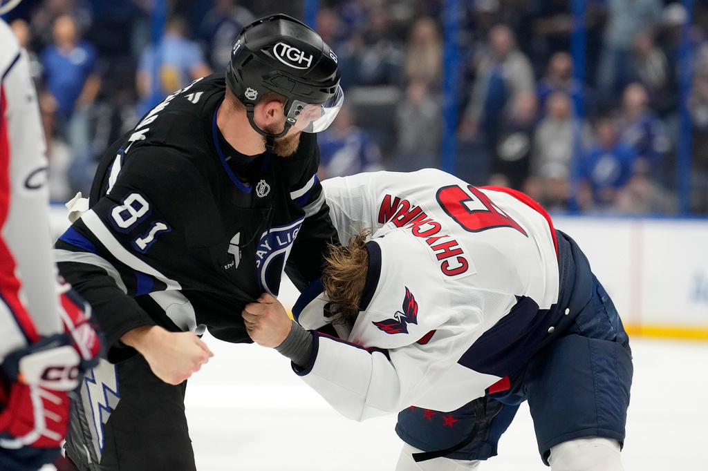 Tampa Bay Lightning defenseman Erik Cernak (81) and Washington Capitals defenseman Jakob Chychrun (6) fight during the third period of an NHL hockey game Saturday, Nov. 8, 2025, in Tampa, Fla. (AP Photo/Chris O'Meara)