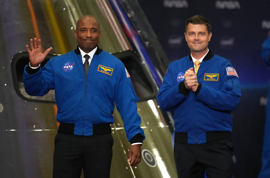 FILE - Artemis II Pilot Victor Glover, left, and Commander Reid Wiseman, right, participate in a Congressional Space Medal of Honor ceremony at NASA's Johnson Space Center, Aug. 28, 2026, in Houston. (AP Photo/Karen Warren, file)