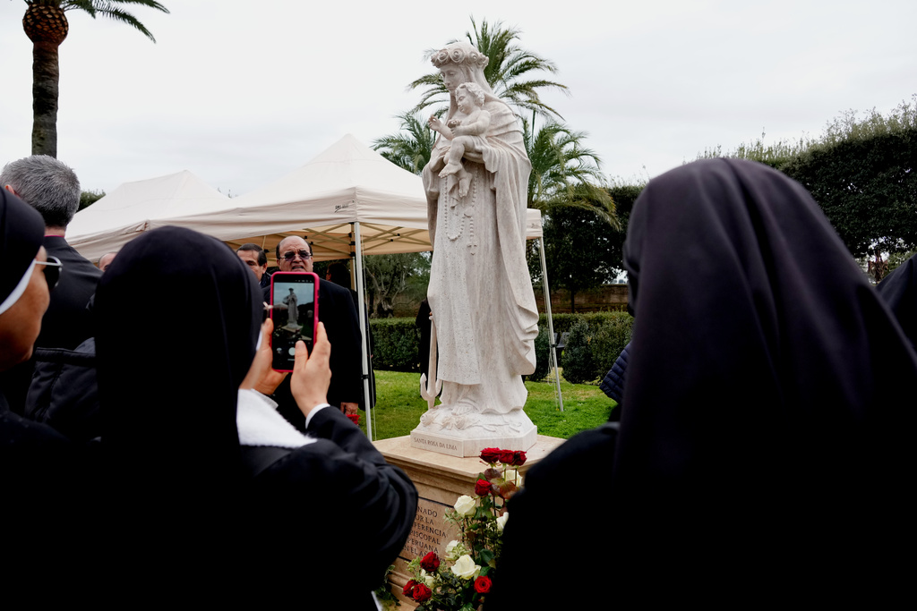 Nuns take photos of statue of the Virgin Mary that was inaugurated by pope Leo XIV in the Vatican Gardens, Saturday, Jan. 31, 2026. (AP Photo/Andrew Medichini)