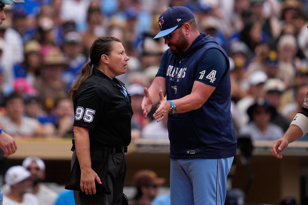 Home plate umpire Jen Pawol (95) speaks with Toronto Blue Jays manager John Schneider during the second inning of a baseball game against the San Diego Padres Sunday, July 12, 2026, in San Diego. (AP Photo/Gregory Bull)