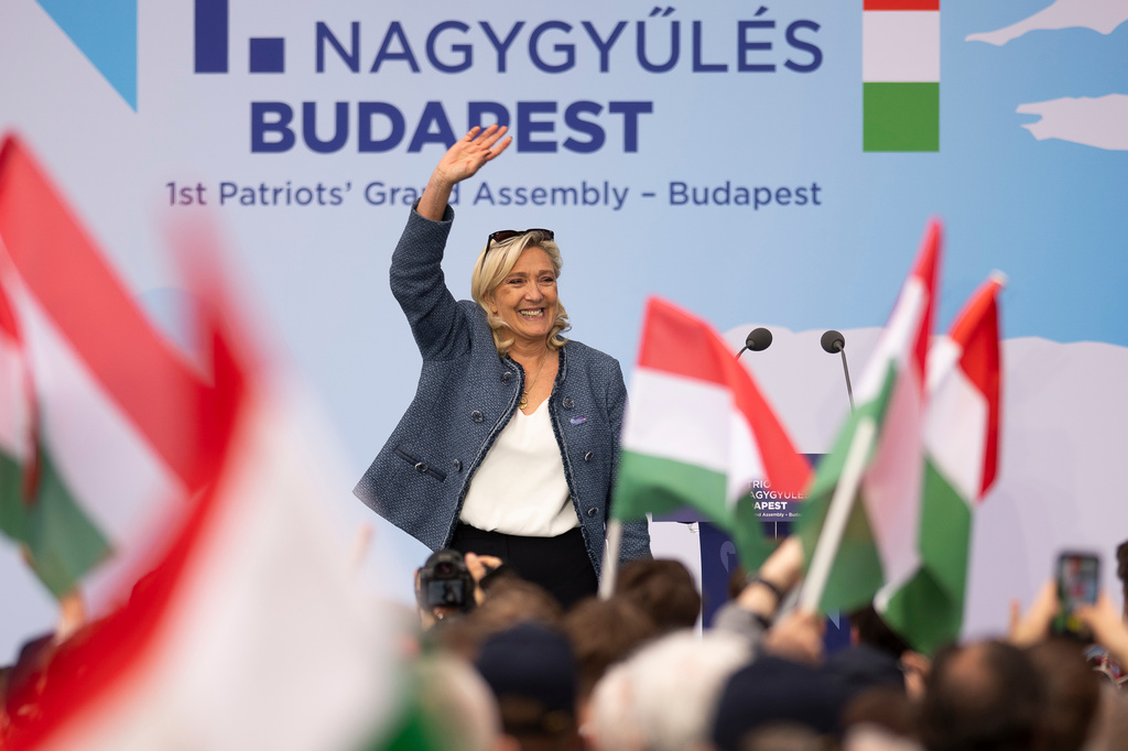France's Marine Le Pen waves after speaking at an assembly of European far-right parties with Hungarian Prime Minister Viktor Orbán Patriots for Europe group, in Budapest, Hungary, Monday, March 23, 2026. (AP Photo/Denes Erdos)