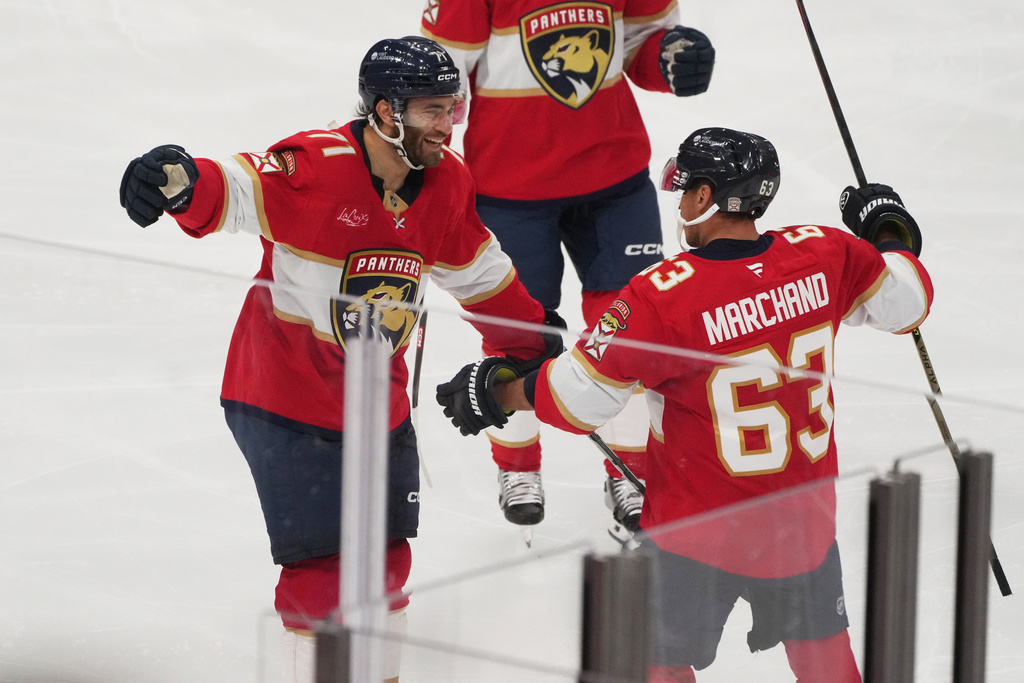 Florida Panthers left wing Brad Marchand (63) celebrates his goal with center Luke Kunin (71) during the third period of an NHL hockey game against the Philadelphia Flyers, Thursday, Oct. 9, 2025, in Sunrise, Fla. (AP Photo/Marta Lavandier)